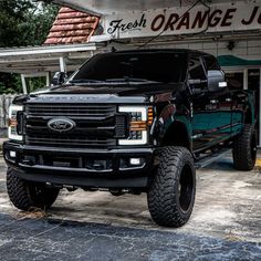 a black truck parked in front of a store