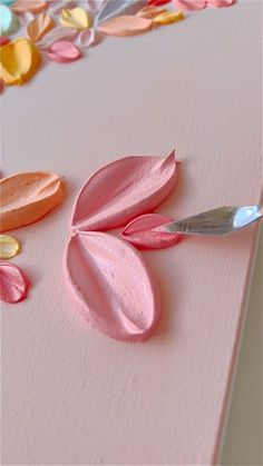 a close up of a piece of paper with flowers on it and a pair of scissors