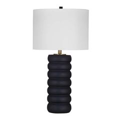 a black lamp with a white shade on it