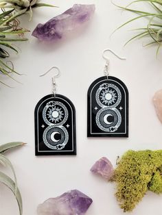 "Snake Acrylic Earrings | Moon & Sun  Mysticism Celestial New Age Mystical | Acrylic Arched Dangle | Witchy Goth Black acrylic, arch charm earrings engraved with white design. This pair features a celestial design with snakes wrapped around a sun and moon. Super lightweight! Other styles/designs also available!  Great for gifts, or, yeah, for yourself!  Nickle free ear wires - can be switched to 14k gold plated or sterling silver for an additional cost. Length: 3\" Charm Height: 2\" Width is 1.25\" at largest part ERaeOn is not responsible for color variation due to screen/monitor settings. Colors are portrayed as accurately as possible! PLEASE READ SHOP POLICIES BEFORE ORDERING" Acrylic Arch, Witchy Goth, Celestial Design, Earrings Moon, Moon Sun, Black Acrylic, Black Acrylics, Acrylic Earrings, White Design