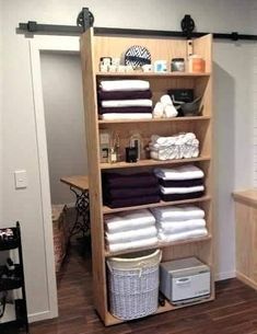 an organized closet with folded towels and other items