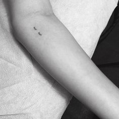 a person with a small tattoo on their arm