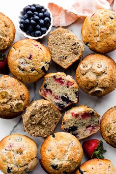 blueberry muffins and berries on a marble surface