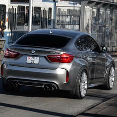 a silver car is parked on the street