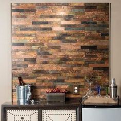 a kitchen area with a refrigerator, stove and wall art on the side of it