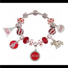 a red and white charm bracelet with charms on the front, an ox logo in the middle