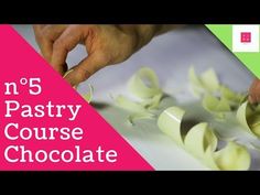 a person cutting up some food on top of a white counter with the words n'5 pastry course chocolate