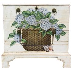 a basket with blue flowers painted on it