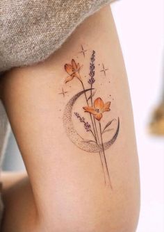 a woman's thigh with flowers on it and a crescent in the middle,