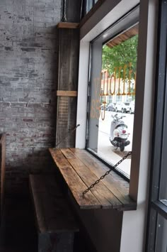 a wooden bench sitting in front of a window