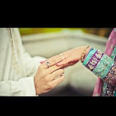 the bride and groom are holding each other's hands