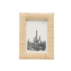 a small photo frame with a cactus in the middle and two cacti behind it