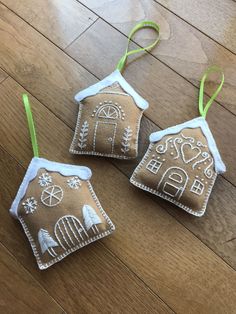 three ornaments are sitting on the wooden floor