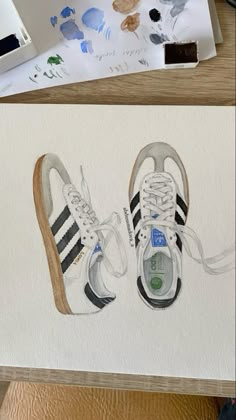 an image of two shoes painted in watercolor and then on paper with colored pencils