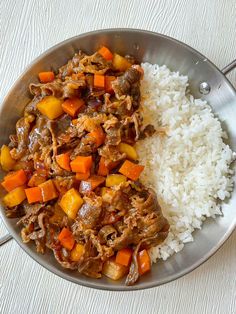 a plate with rice, meat and vegetables on it