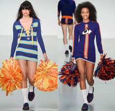 two models walking down the runway with cheerleaders in orange and blue pom poms