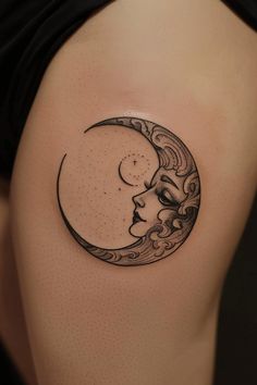 a woman's thigh with a crescent moon tattoo on it