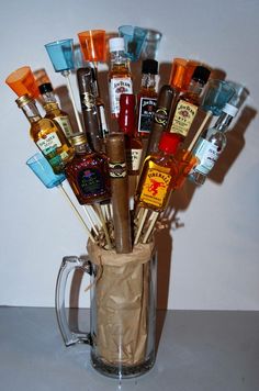 a glass mug filled with lots of different types of liquor