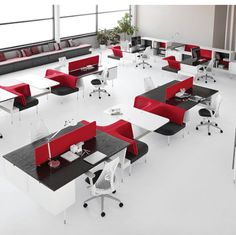 an office with red and white desks and chairs