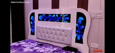 a bed with purple and blue flowers on the headboard is shown in this image