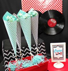 a table topped with cake pops and vinyl records