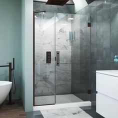 a bathroom with a glass shower door next to a bathtub and sink in it