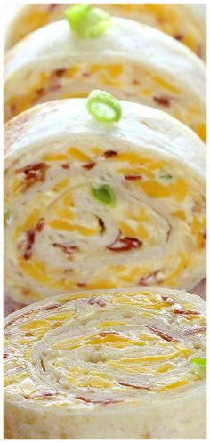 several rolls with cheese and green onions on them are arranged in the shape of spirals