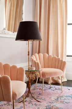 a living room filled with furniture and a lamp on top of a table next to a window