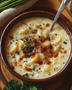 a bowl filled with soup and garnished with parsley next to a spoon