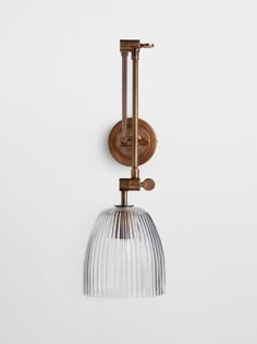 an old fashioned wall light with a glass shade