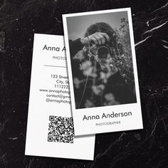 a black and white business card with an image of a woman holding a camera on it