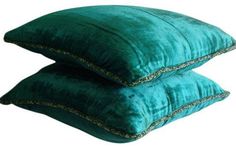 two green pillows sitting on top of each other