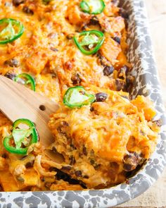 a casserole dish with green peppers and cheese on it, ready to be eaten