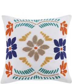 an embroidered pillow with flowers and leaves on the front, in blue, orange and white colors