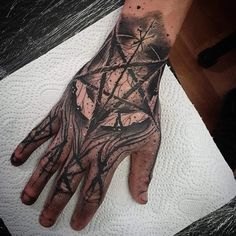 a person's hand with a tattoo on it