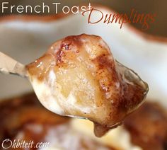 a spoon full of french toast dumplings in a white bowl