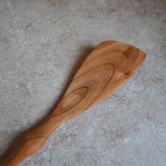 a wooden spoon sitting on top of a white floor