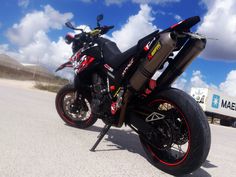 a black and red motorcycle parked on the street