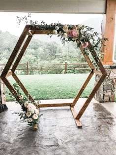 an outdoor ceremony setup with flowers and greenery