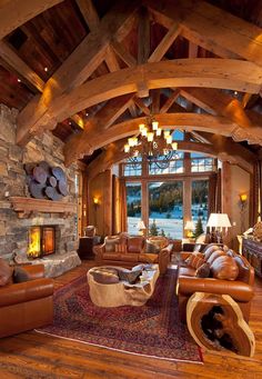 a living room filled with lots of furniture and a fire place in the middle of it