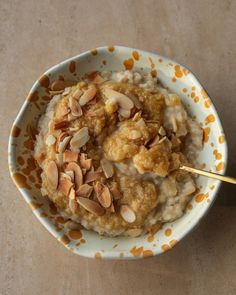 a bowl filled with oatmeal topped with nuts