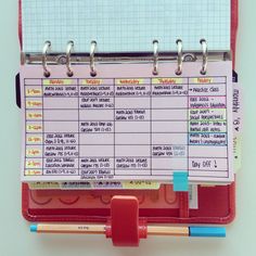 a clipboard attached to a wall with notes and pencils