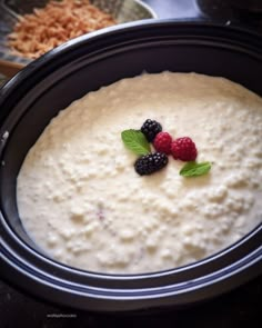 a crock pot filled with pudding and berries