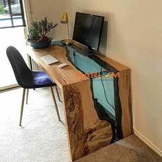 a desk made out of wood with a computer on it and a chair next to it