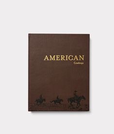 an old book with the title american cowboys written in gold on brown paper, sitting on a white surface