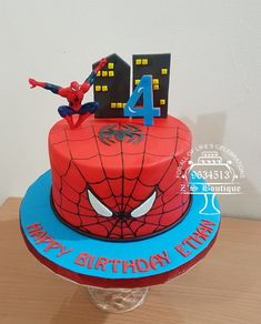 a spiderman birthday cake with the number four on it