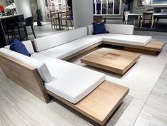 a white couch sitting on top of a hard wood floor next to a wooden table