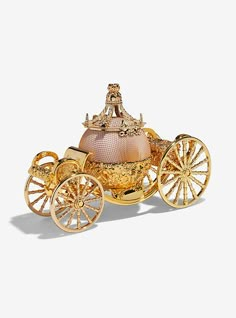 a golden carriage with a pink top and gold trimmings on the sides, sitting in front of a white background