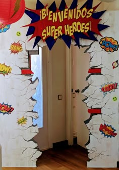 an entrance to a room decorated with comic book pages and pop - up paper lanterns