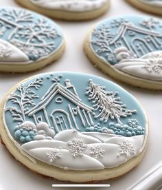 cookies decorated with frosting and icing are on a baking sheet in the shape of houses